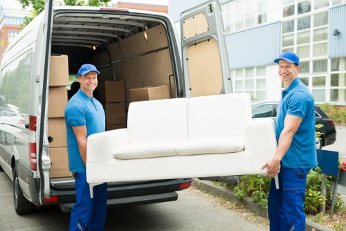 Man and van team carrying furniture safely during a move