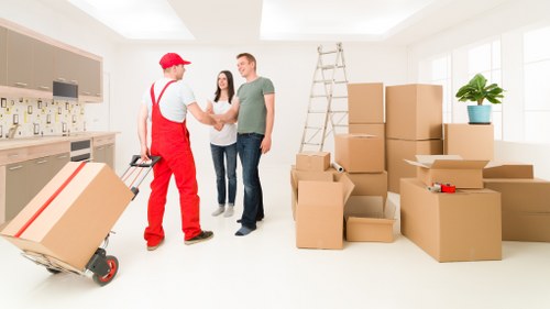 Removal team carrying furniture through a typical Streatham property entrance
