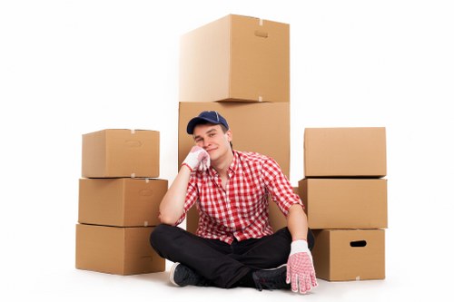 Movers carrying furniture through a Streatham property